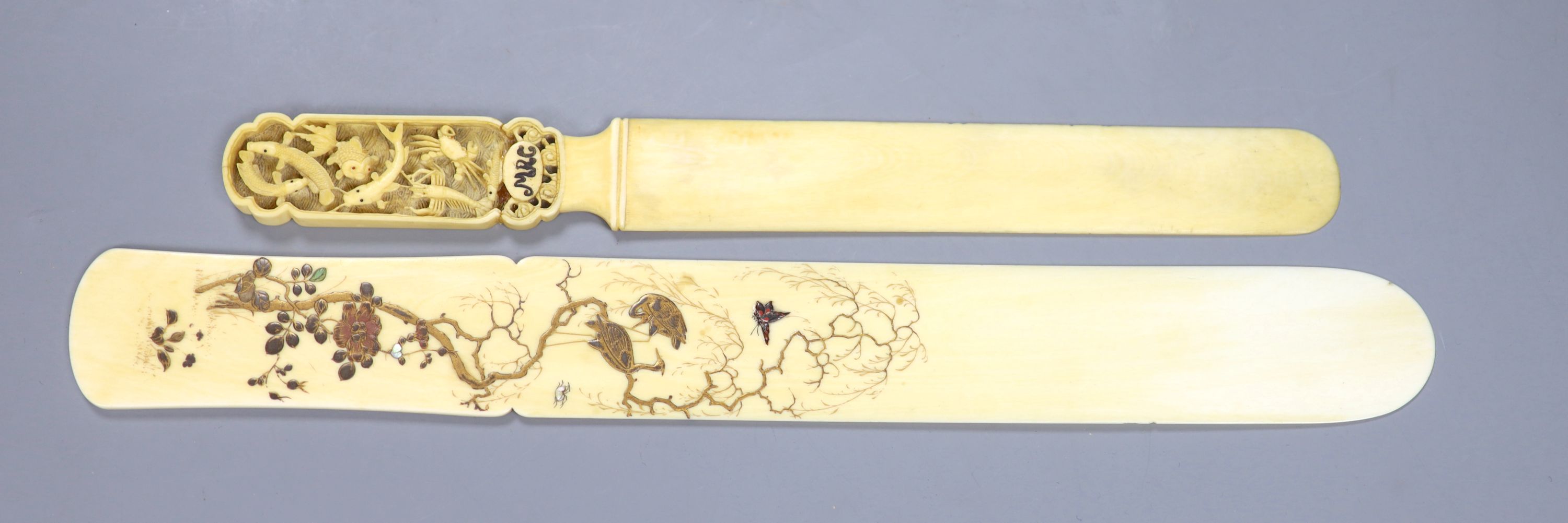 A Meiji period Japanese shibayama style ivory page turner, decorated with birds, flowers and butterflies, 30.5cm long,